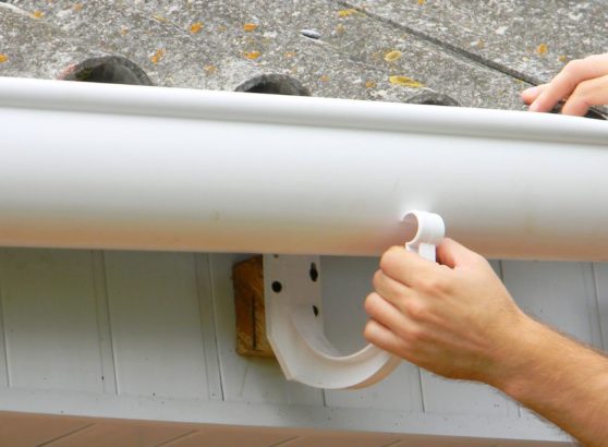 Worker installing gutter