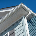 white seamless gutter guard system installed on a house