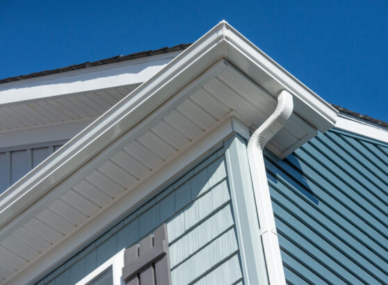 white seamless gutter guard system installed on a house