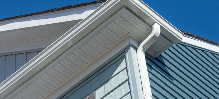 white seamless gutter guard system installed on a house