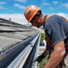 gutter repair expert working on residential roof