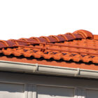 a roof with red tiles and white gutters ready for leaf guard installation