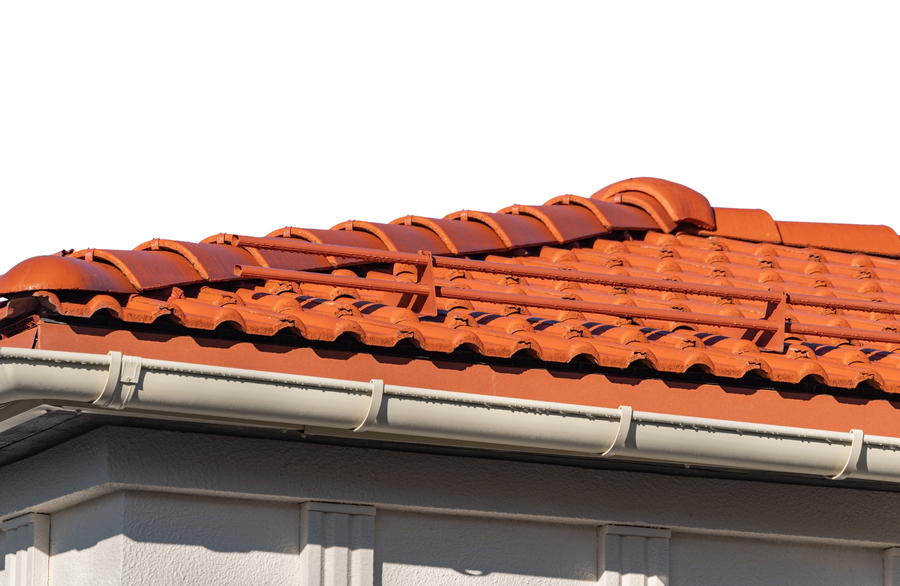 a roof with red tiles and white gutters ready for leaf guard installation